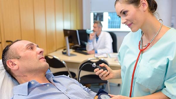 What should hypertensive patients do if their heart rate is found to be too fast during physical examination?